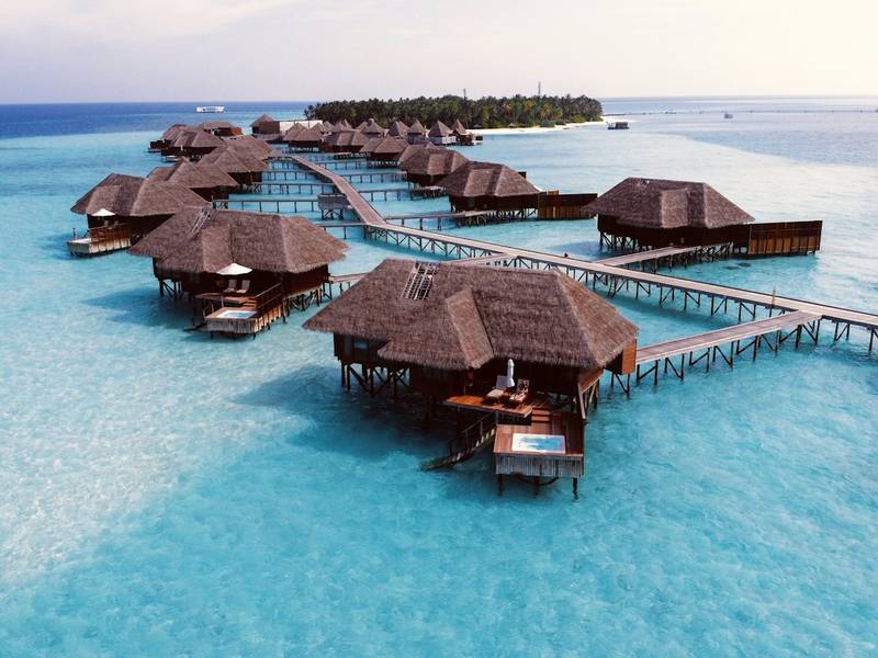 Overwater villas on a turquoise lagoon in the Maldives