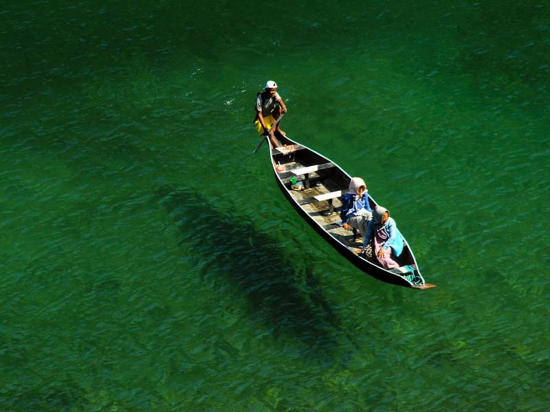 Boat floating on the clear green Umngot river at Dawki, Meghalaya